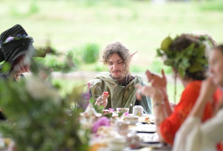 Fairy Garden Tea Party. People sitting at a table and drinking tea.